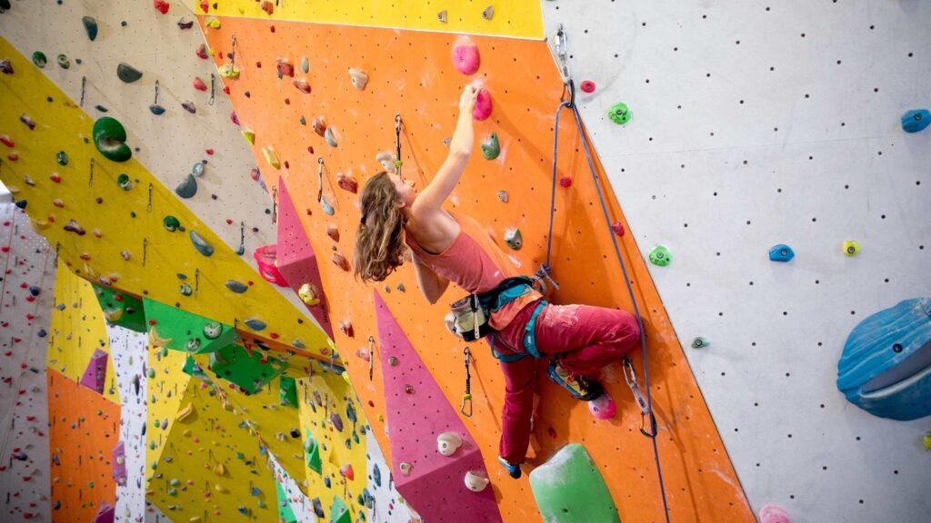 Person in einer Kletterhallte beim klettern